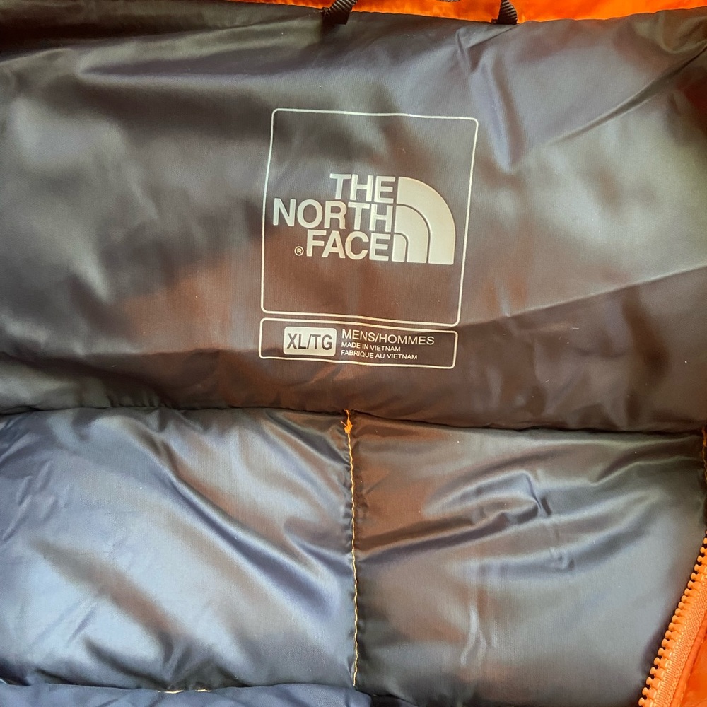 Northface face orange puffer jacket